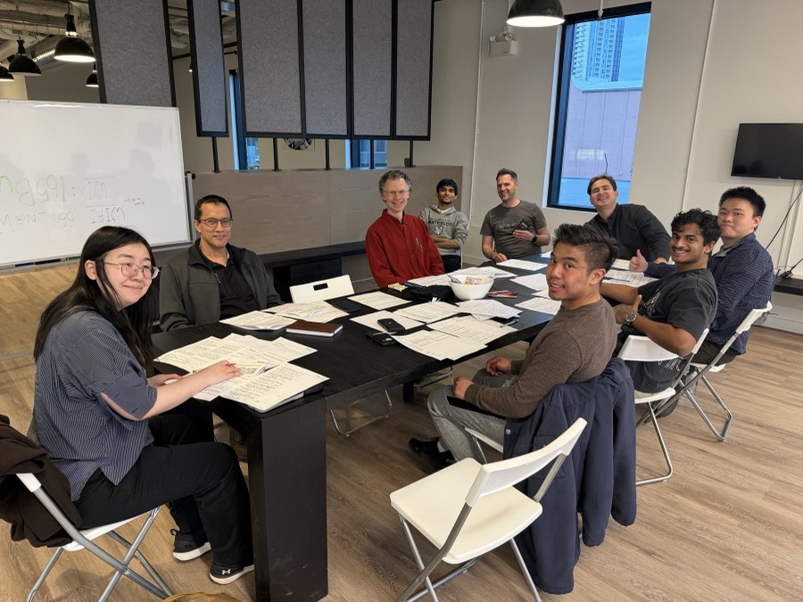 Mind Club session — participants seated around a table doing pen and paper exercises